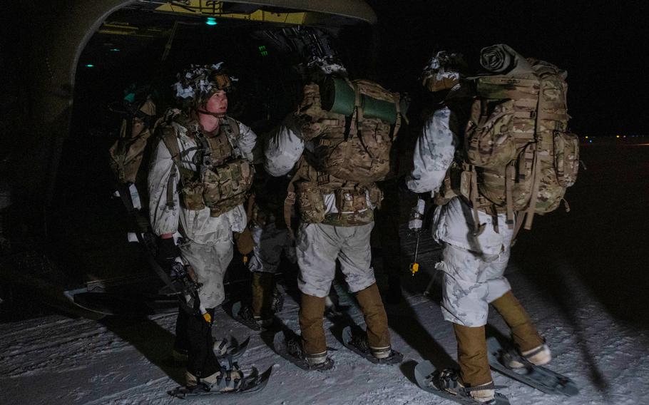 U.S. Army soldiers assigned to Bounty Hunter Troop, 5th Squadron, 1st Cavalry Regiment, 1st Infantry Brigade Combat Team, 11th Airborne Division, load onto a CH-47 Chinook to depart for an Air Assault during Operation Wolf Valkyrie, Fort Wainwright, Alaska, Nov. 30, 2023. 