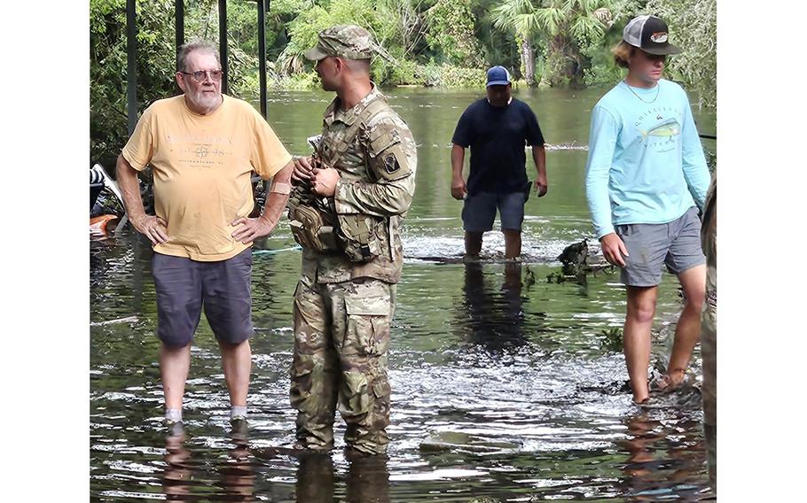 A member of the Florida National Guard conducts wellness checks to support the Hurricane Idalia recovery effort in Steinhatchee, Fla., on Aug. 30, 2023. 