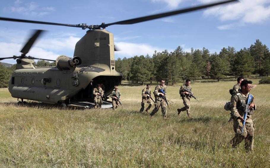 Cadets practice infiltration after an Army CH-47 Chinook helicopter landing during the Special Warfare Orientation Course at the U.S. Air Force Academy in Colorado Springs, Colo., June 28, 2022.