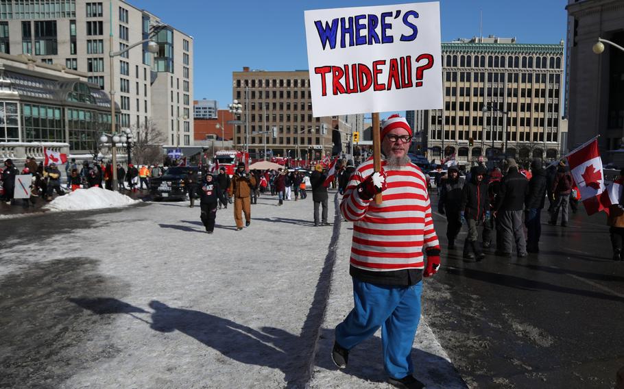 A protester carries a sign during the “Freedom Convoy” demonstration in Ottawa on Feb. 5, 2022. 