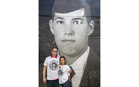 Scott and Patty St. Clair stand in front of a mural of an image of their wrongfully detained son on Wednesday, April 30, 2025 in Washington. The Bring Our Families Home Campaign, a coalition of families dedicated to bringing home loved ones who have been wrongly detained in foreign countries, gathered at the mural, which features the faces of their imprisoned relatives, to raise awareness of their plight. 