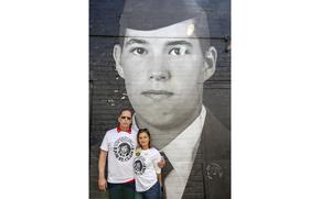 Scott and Patty St. Clair stand in front of a mural of an image of their wrongfully detained son on Wednesday, April 30, 2025 in Washington. The Bring Our Families Home Campaign, a coalition of families dedicated to bringing home loved ones who have been wrongly detained in foreign countries, gathered at the mural, which features the faces of their imprisoned relatives, to raise awareness of their plight. 