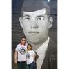 Scott and Patty St. Clair stand in front of a mural of an image of their wrongfully detained son on Wednesday, April 30, 2025 in Washington. The Bring Our Families Home Campaign, a coalition of families dedicated to bringing home loved ones who have been wrongly detained in foreign countries, gathered at the mural, which features the faces of their imprisoned relatives, to raise awareness of their plight. 
