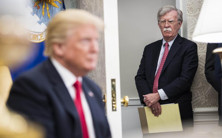 National security adviser John Bolton listens as President Donald Trump speaks with Nigerian President Muhammadu Buhari during a meeting at the White House on April 30, 2018. 