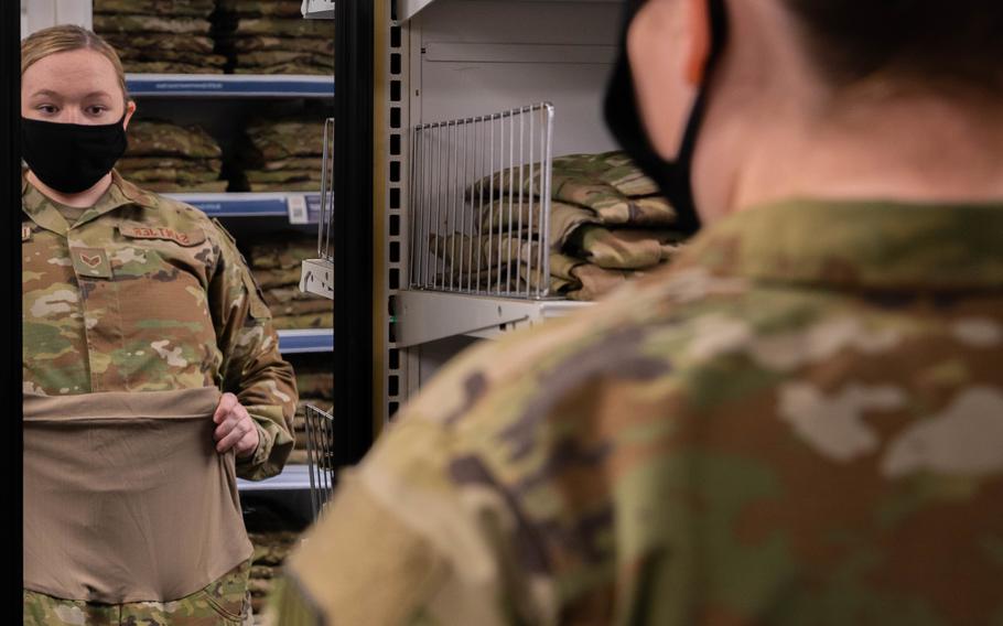Senior Airman Quynn Santjer, a unit deployment manager for the 94th Fighter Squadron, shops for maternity uniforms at Langley Air Force Base, Va., Dec. 2, 2021. The Air Force updated its leave policy recently to allow airmen extra time off to undergo fertility treatments at a military hospital.