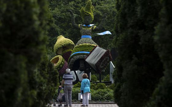 An Alice topiary stands in the “Alice’s Adventures in the Garden” exhibit at Memphis Botanic Garden Tuesday, May 10, 2022, in Memphis, Tenn. The exhibit will remain open until Oct. 31. (Christine Tannous//The Commercial Appeal via AP)