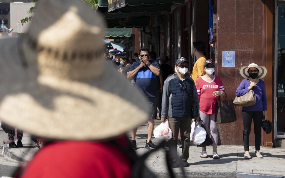 Visitors to Los Angeles' Chinatown wear masks even outdoors after L.A. County began requiring them to be worn in public indoors.  