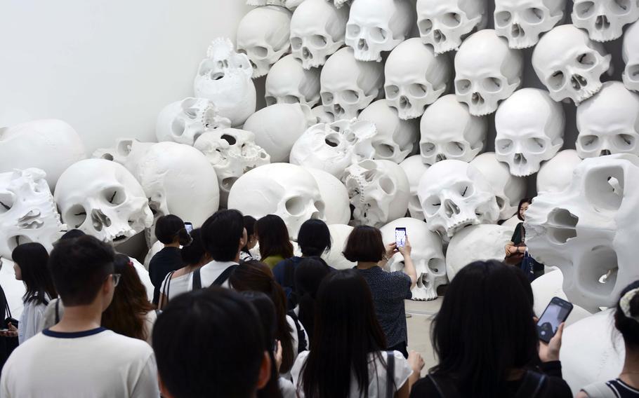 A crowd gathers to photograph "Mass," part of sculptor Ron Mueck’s exhibition at the National Museum of Modern and Contemporary Art in Seoul, South Korea.