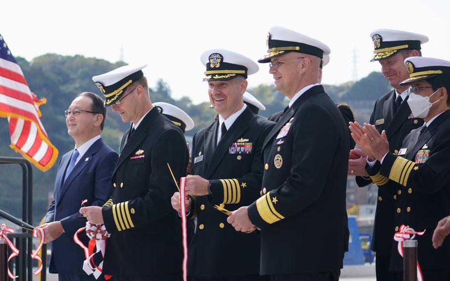 From left, Penta-Ocean Construction Co. President Takuzo Shimizu, NAVFAC Far East commander Capt. Lance Flood, Yokosuka base commander Capt. Les Sobol and Naval Forces Japan commander Rear Adm. Carl Lahti pose after a ceremonial ribbon cuttingat Pier 5, Yokosuka Naval Base, Japan, on Nov. 18, 2022. 