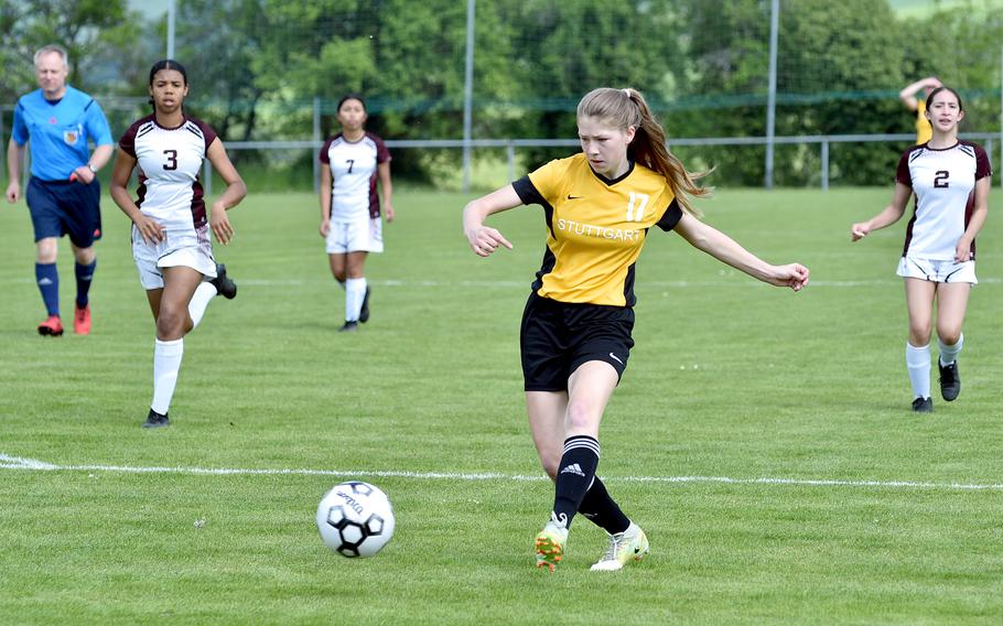 Stuttgart's Haley Wells shoots during a pool-play game against Vilseck on May 15, 2023, in Reichenbach-Steegen, Germany. Trailing, from left, are the Falcons' Valerie Vizcaino and Arianna Almanza.