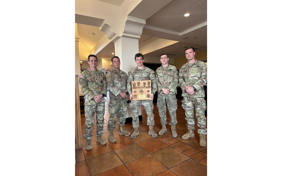 The Fort Bragg Men’s Bataan Memorial Death March Team stands together after claiming victory in the military heavy division of the 34th Bataan Memorial Death March, Sunday, March 19, 2023.