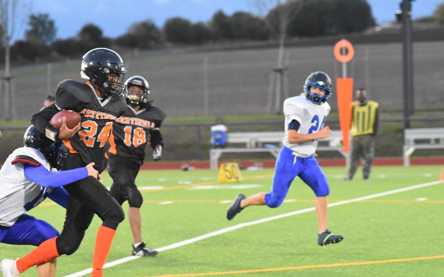 Spangdahlem’s Robert Leggett tries to avoid being tackled while running the ball Friday night during the Sentinels’ home game at Spangdahlem Air Base, Germany, against Division III foe Brussels.