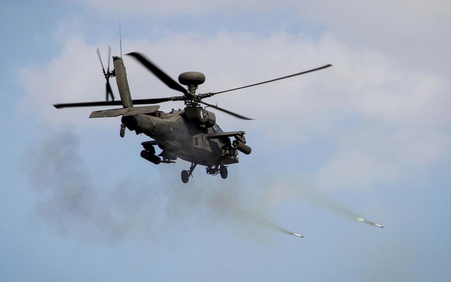 An AH-64 Apache fires rockets during joint training.