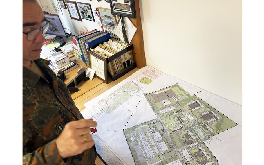 A man looks at blueprints.