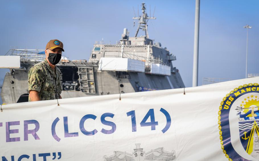 In an Aug. 27, 2020 photo, Vice Adm. Roy Kitchener, commander of the Naval Surface Force of the U.S. Pacific Fleet, walks aboard the littoral combat ship USS Manchester for a tour of the ship.