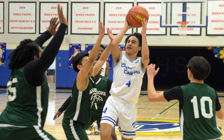 Osan's Travus Boyd rises for a shot between Daegu defenders during Tuesday's 71-43 win by the Cougars.