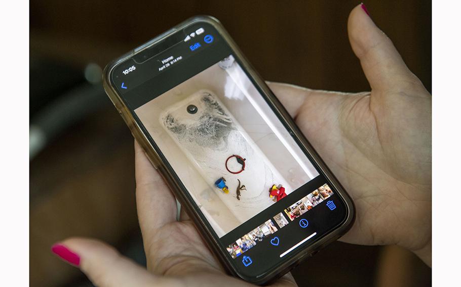 Jessica Conard shows a photo of black residue in her bathtub after running the water from her private well following the train derailment.