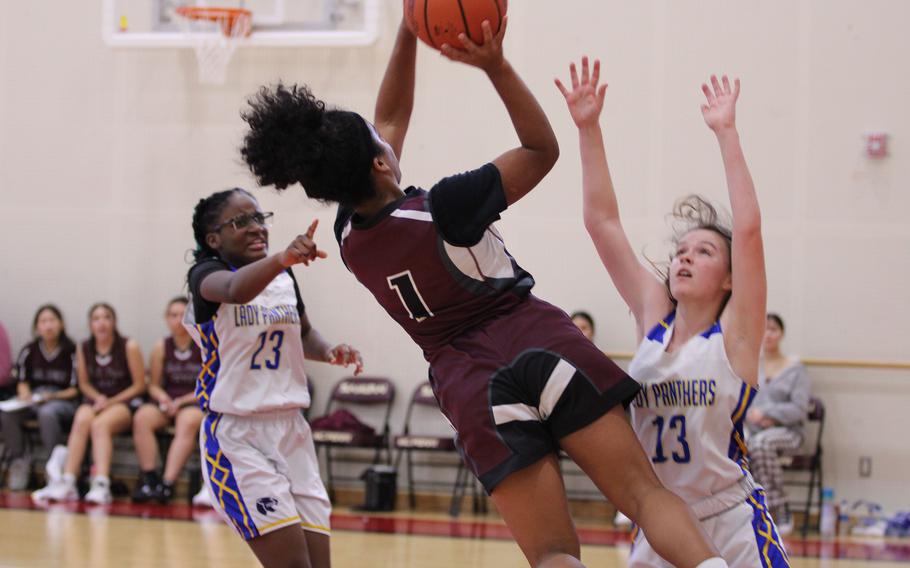 Matthew C. Perry's Ivanelis Nieves-Burmedez puts up an off-balance shot against Yokota's Beverly Gardner and Hailey Riddels during Saturday's DODEA-Japan girls basketball game. The Panthers won 42-27.