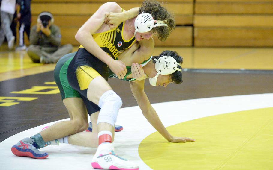 Kadena 114-pounder Brayden Holmes tries to gain the advantage on Kubasaki's Noah Starr during Wednesday's Okinawa wrestling regular-season finale. Holmes won by technical fall 10-0 in 1 minute, 22 seconds, and the Panthers won the meet 34-28, completing a six-meet regular-season sweep.