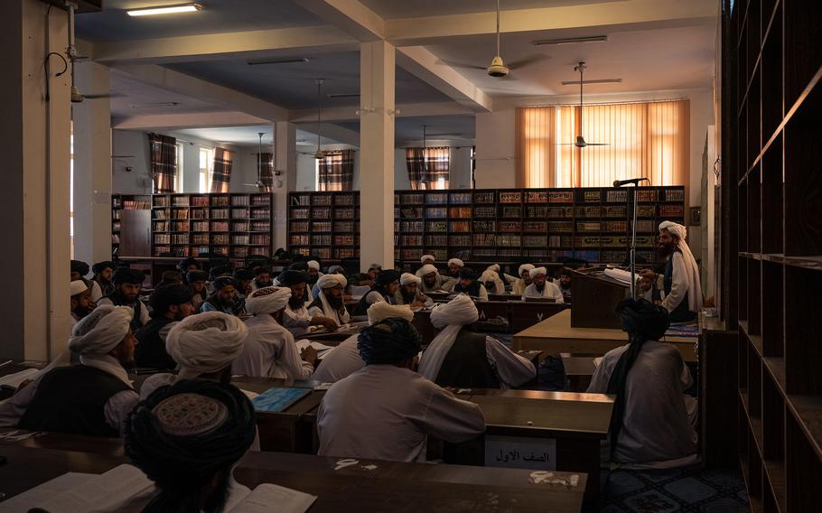 A Taliban scholar teaches doctoral students at a madrassa in Kandahar. The regime is subsidizing hundreds of the religious schools for boys and men.