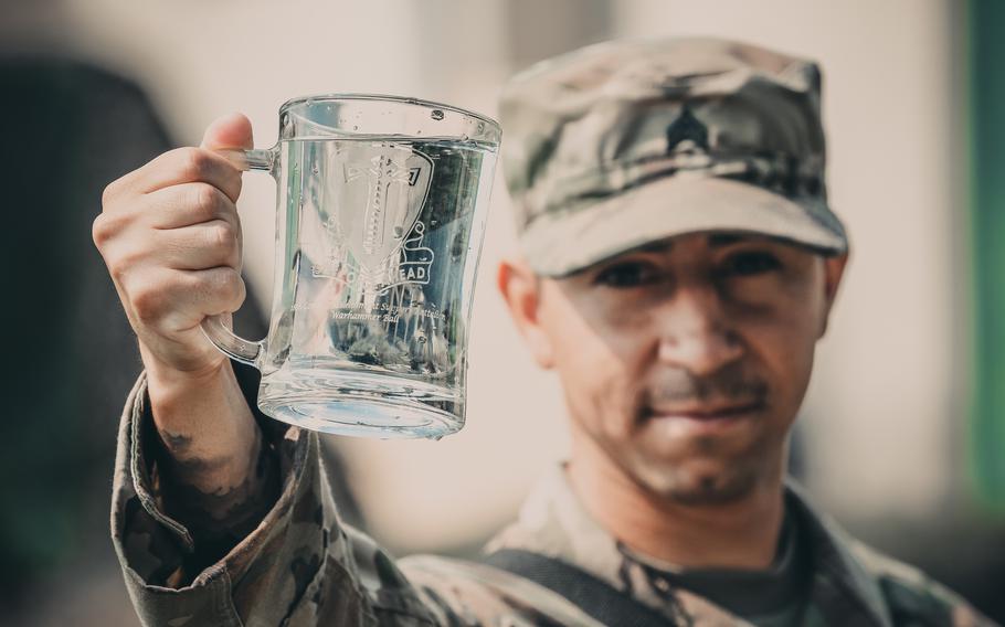 Sgt. Daniel Baudoin, a water purification specialist with the 240th Composite Supply Company of Baumholder, Germany, shows off freshly purified water he and his team produced during an exercise in Poland, June 2, 2018. German officials asked residents in Birkenfeld district, which includes Baumholder, to boil their tap water due to bacteria contamination detected before the Easter weekend.