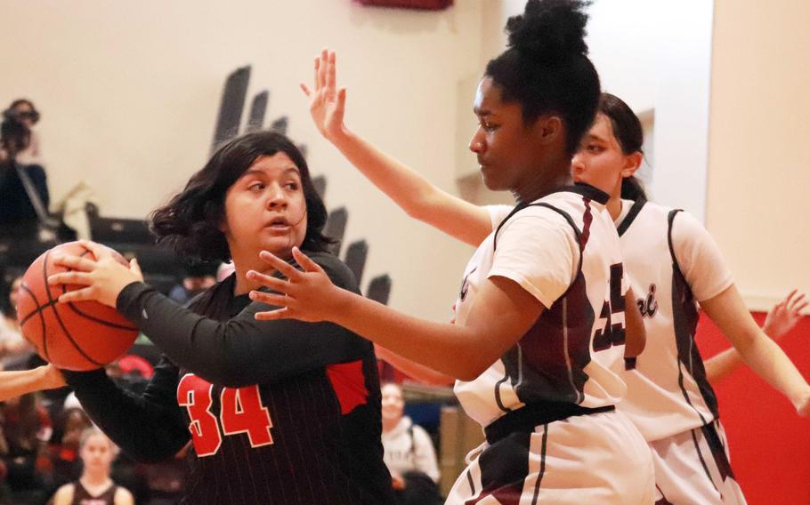 Matthew C. Perry's Kaiden Bradley guards Nile C. Kinnick's Alyssa Lopez during Saturday's DODEA-Japan girls basketball game. The Red Devils won 38-19.
