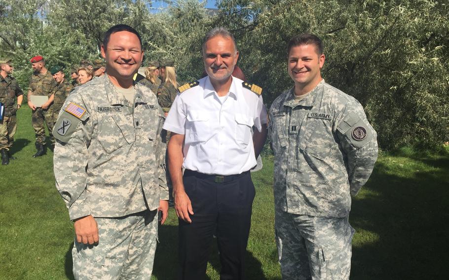 Maryland National Guard Capt. Kurt M. Rauschenberg, right, and Utah National Guard Lt. Col. Steven A. Fairbourn stand with the commander of the Center of Military Information in Berlin, Germany, Sept. 7, 2015.