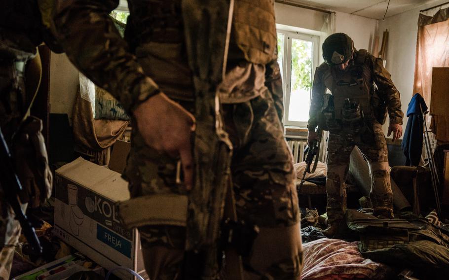 Kraken Regiment members inspecting a house used by Russian occupying forces as their base in Ruska Lozova.