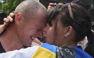 A Ukrainian serviceman hugs his wife after returning from captivity.