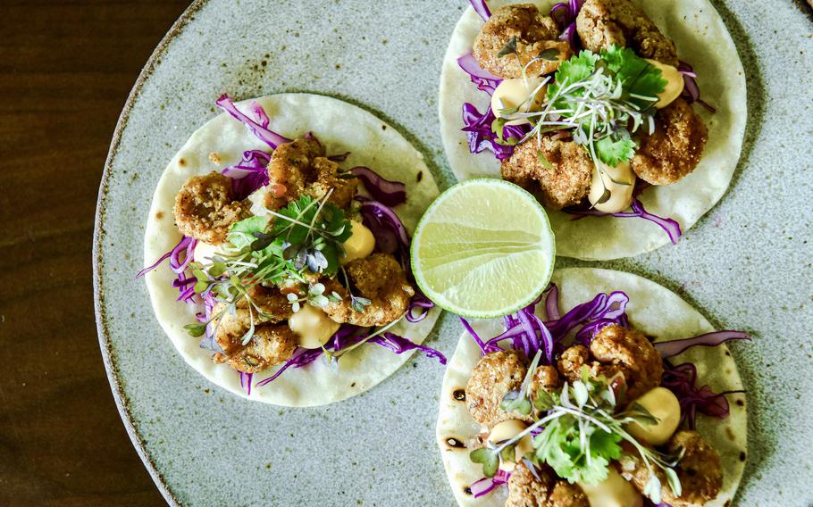 Petiole Cafe's bang bang shrimp tacos, made from tofu, are tossed in a spicy vegan mayo sauce and topped with fresh purple cabbage and cilantro.