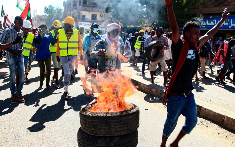 Sudanese demonstrators take to the streets of the capital Khartoum as tens of thousands protest against the army's Oct. 25 coup, on Thursday, Dec. 30, 2021.