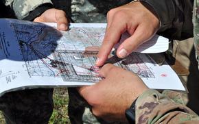 A closeup of fingers pointing at a map.