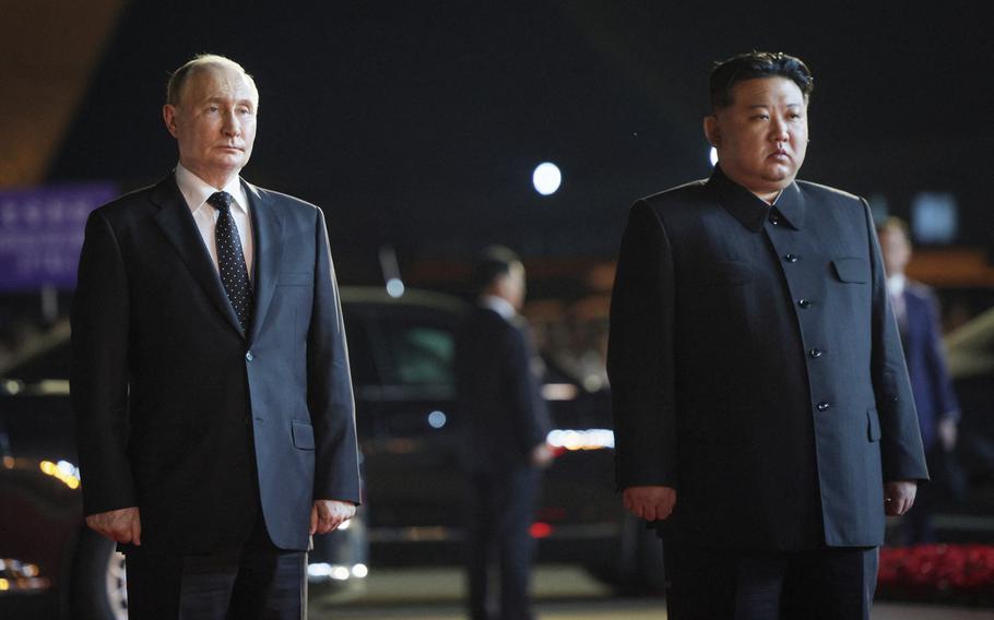 Russian President Vladimir Putin stands beside North Korean leader Kim Jong Un.