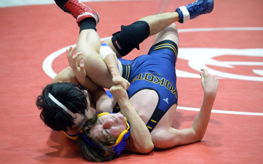 St. Mary’s Hiroyuki Sen locks in a cradle on Yokota’s Dean Lingle, pinning him in 42 seconds to win the 114-pound final.