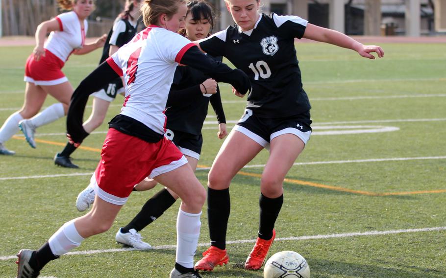 Nile C. Kinnick’s Ainslie Rochholz dribbles against Zama‘s Olivia Parish during Saturday’s Trojan War Cup match. The Red Devils won 6-0.