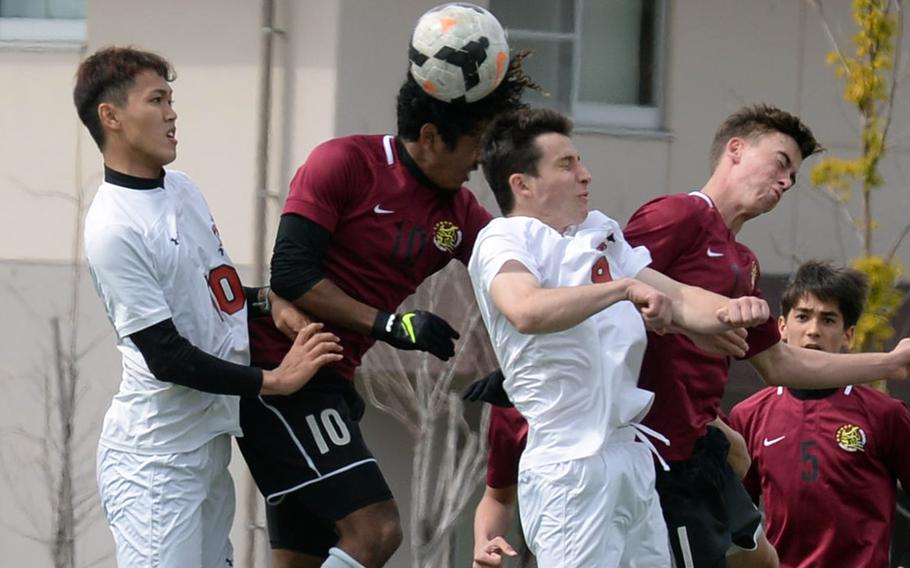 Matthew C. Perry's Denzel Gray gets a head on the ball against E.J. King's Kyo Tominaga and Joseph McGrath during Saturday's DODEA-Japan soccer match. The Samurai won 3-1.
