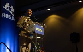 Xavier Brunson stands in uniform behind a podum that reads “LANPAC.”