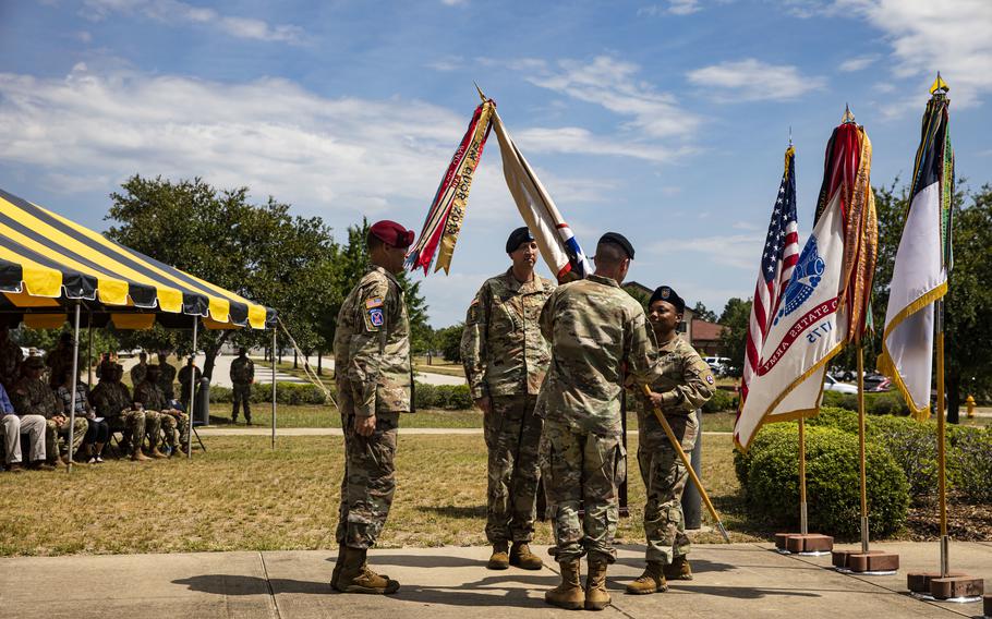 Command Sgt. Maj. Phelicea Redd, outgoing command sergeant major, 3rd Expeditionary Sustainment Command, passes the organizational colors to Brig. Gen. Lance Curtis, outgoing commander, 3rd ESC, XVIII Airborne Corps, as Col. John (Brad) Hinson, incoming commander assumes command during the 3rd ESC Change of Command and Relinquishment of Responsibility on Fort Bragg, N.C., June 10, 2022.