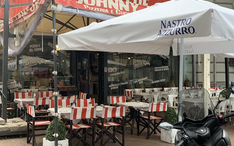 Johnny Take Ue includes outdoor and indoor seating at its Corso Vittorio Emanuele location in Naples' Mergellina neighborhood. 