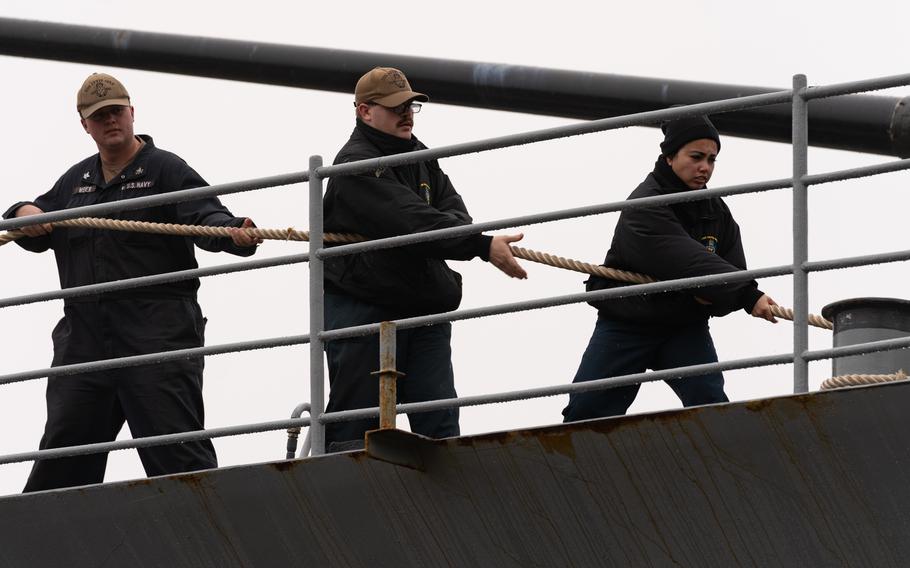 Sailors assigned to the guided-missile cruiser USS Leyte Gulf heave in a mooring line as the ship departs Naval Station Norfolk, Va., Jan. 28, 2024, for a scheduled deployment to the U.S. 4th Fleet area of operations.