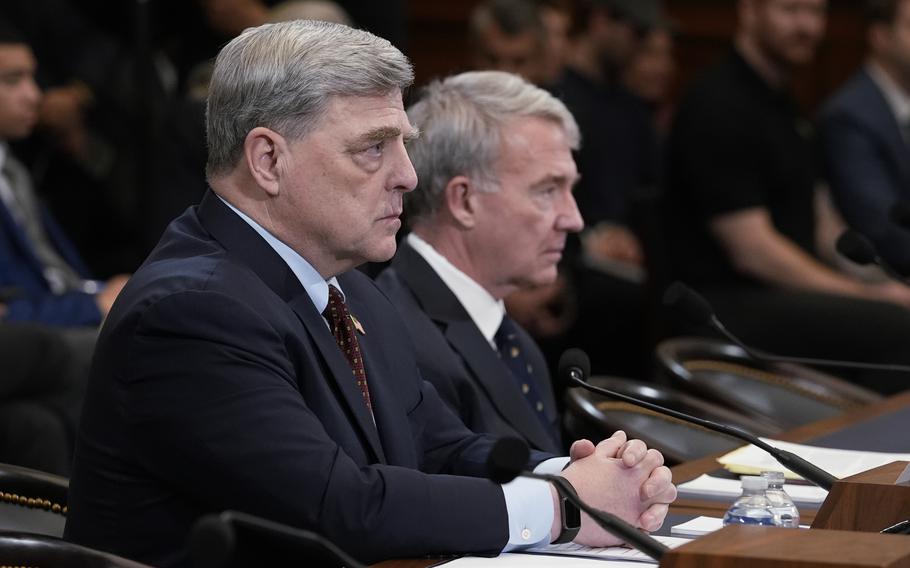 Retired Gen. Mark Milley, left, and retired Gen. Kenneth McKenzie speak to the House Foreign Affairs Committee at the Capitol in Washington on March 19, 2024.
