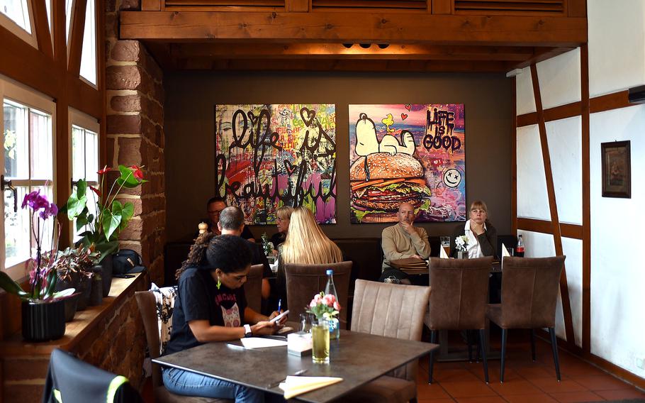 Patrons sit at tables in a restaurant in Germany.