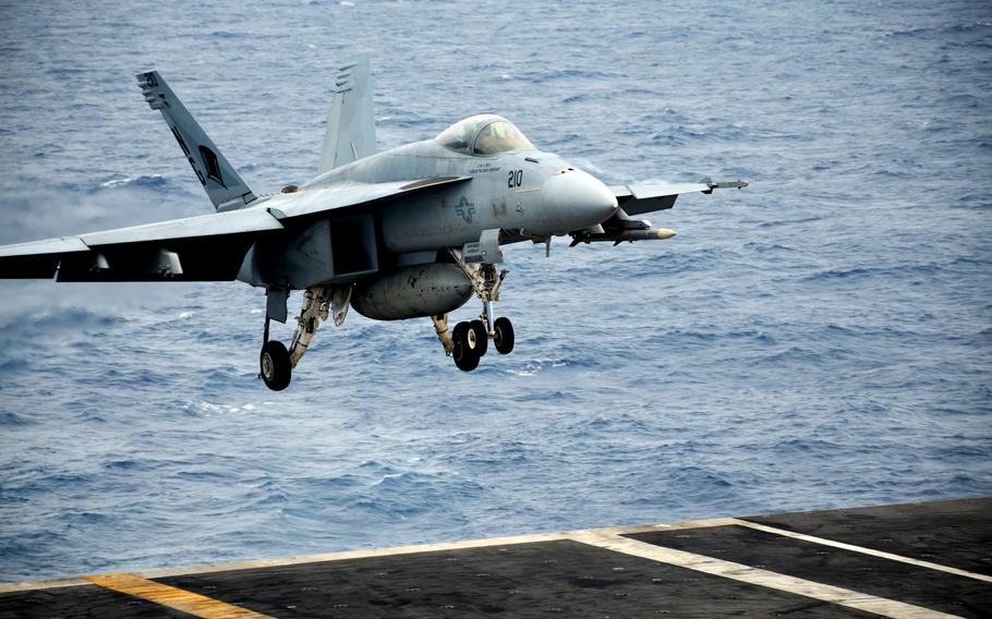 An F-18 Super Hornet lands aboard the aircraft carrier USS Abraham Lincoln in the Philippine Sea, Saturday, April 23, 2022.