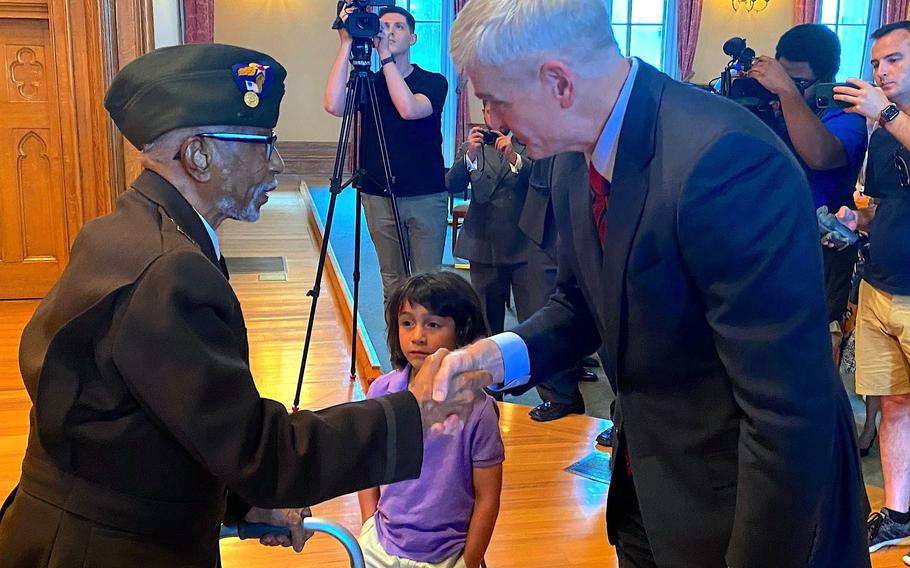 World War II veteran Johnnie Jones shakes the hand of U.S. Sen. Bill Cassidy on Saturday, June 26, 2021, in Baton Rouge, La.