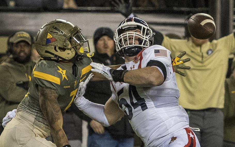 The ball bounces off Navy's Will Harbour (54) as he defends against a pass to Army's Jemel Jones (7) during the 123rd Army-Navy football game played at at Philadelphia’s Lincoln Financial Field on Saturday, Dec. 10, 2022. Army went on to beat Navy 20-17 in double overtime.