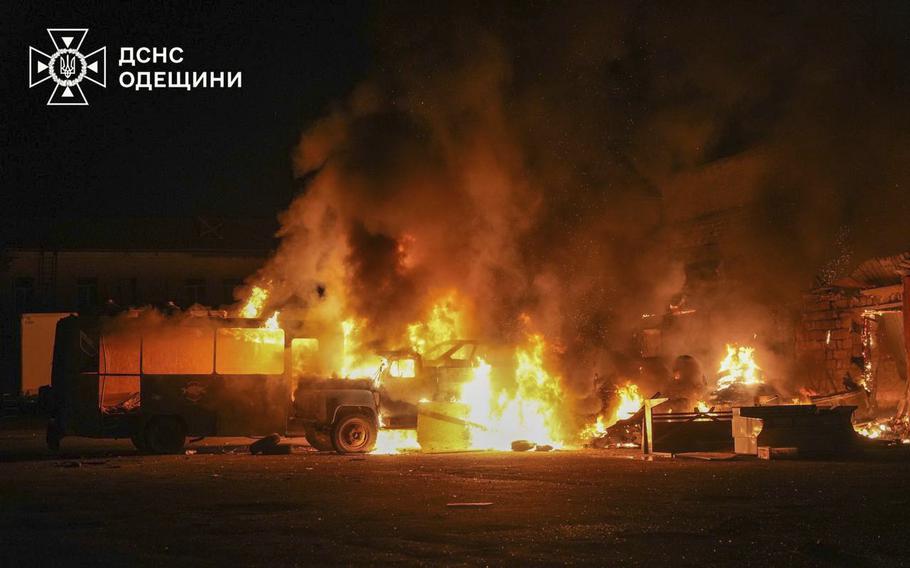 Flames rise from a truck and a structure in Ukraine.