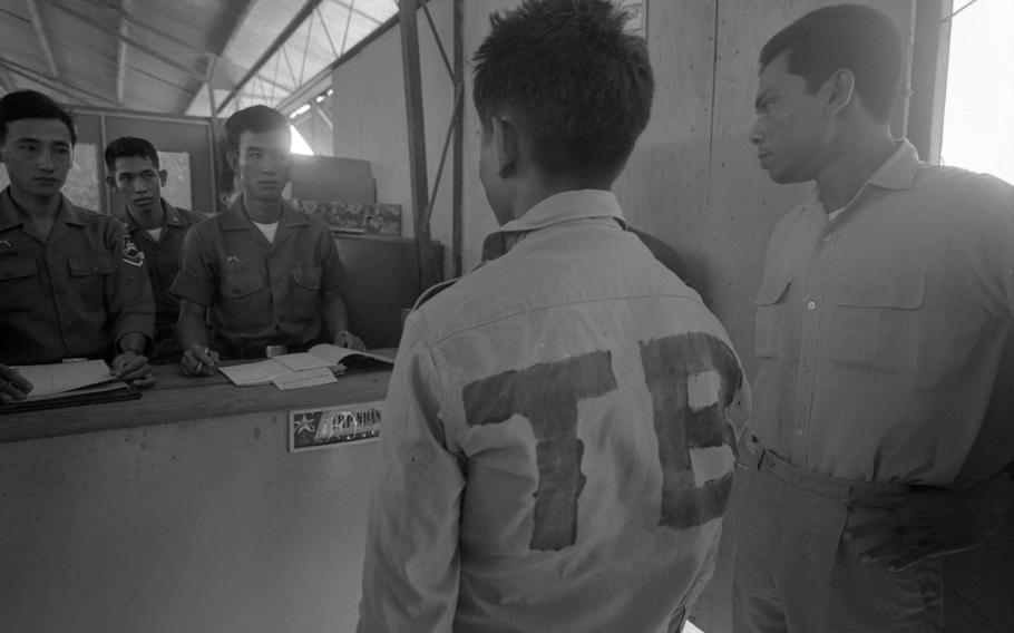 Viet Cong prisoners are classified into groups and photographed upon entering Bien Hoa POW camp. In April 1968 the camp held some 900 male and 85 female prisoners. The male prisoners are segregated in groups by their rank — 14 officers, 30 non-coms and 830 privates.