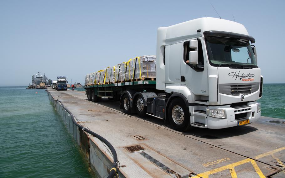 Humanitarian aid is transported along the U.S.-built temporary pier before entering the beach in Gaza on May 18, 2024.