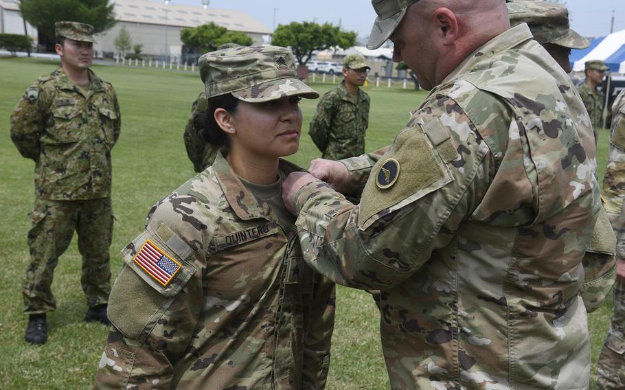 Sgt. Leslie Quinteros receives her U.S. Army Expert Soldier Bage at Sagami General Depot, Japan, April 26, 2024.