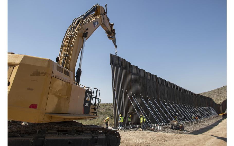 A U.S. Army Corps of Engineers South Pacific Border District contractor crew places a bollard style barrier panel along the U.S.-Mexico border near Naco, Arizona, Oct. 6, 2020.